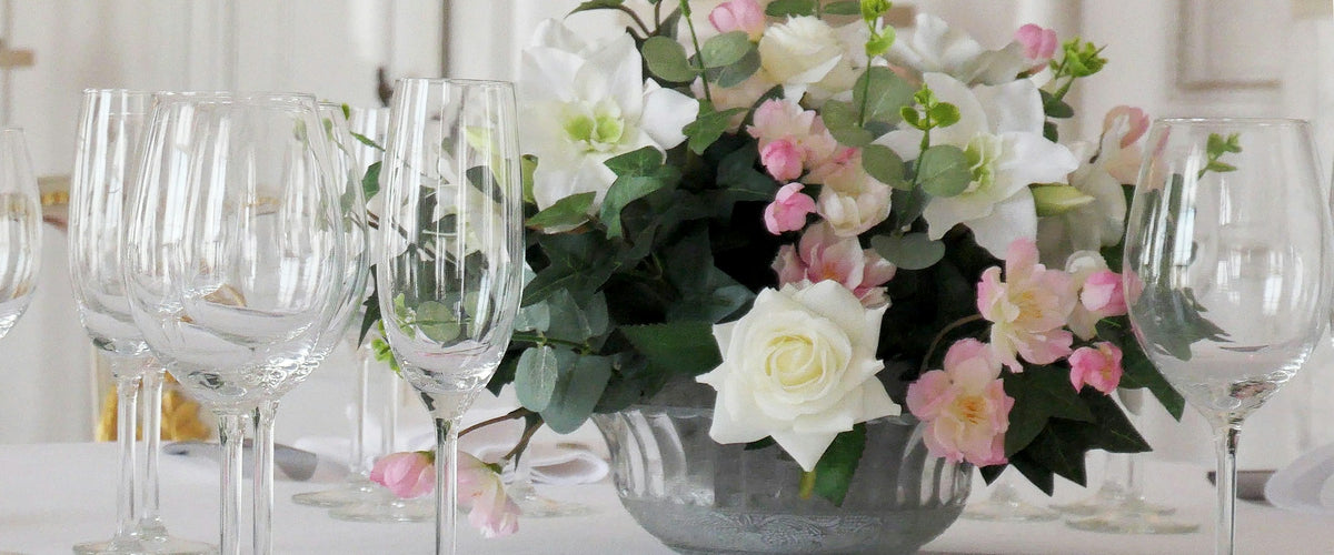 Table decorated with pink and white roses and glassware