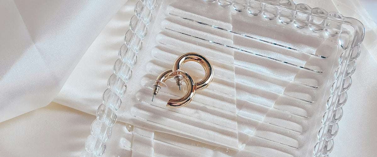 Gold rings resting on a glass jewelry tray