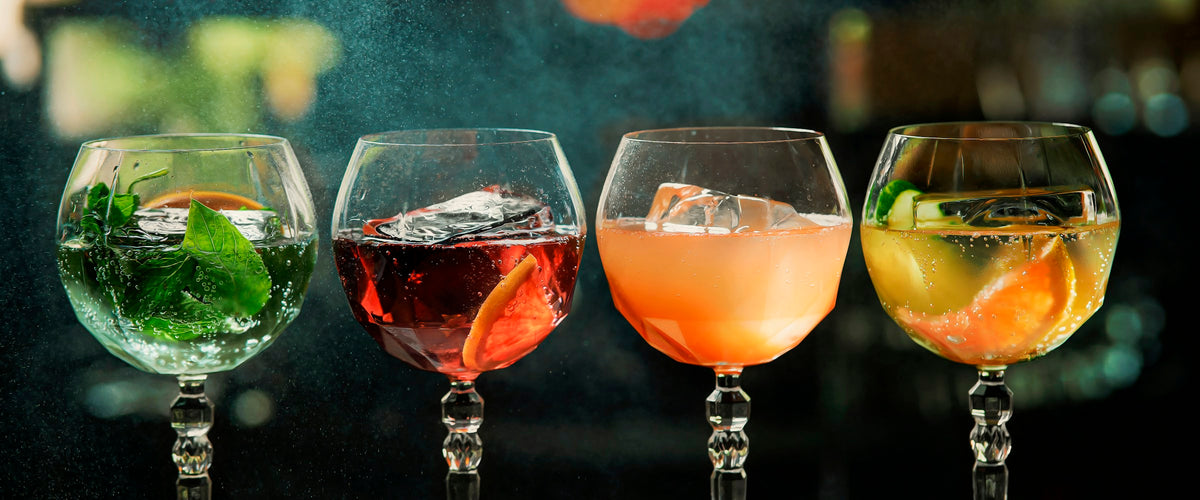 Row of cocktails in stemmed glasses