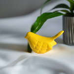 yellow bird figurine