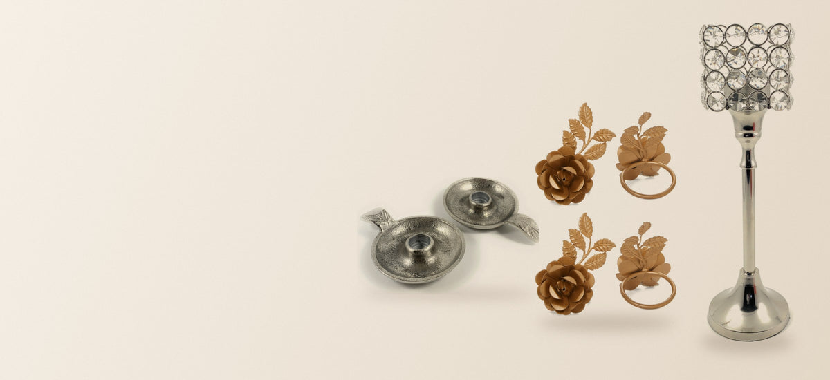 Vibhsa crystal hurricane candle holder, gold rose napkin rings and silver candle dishes